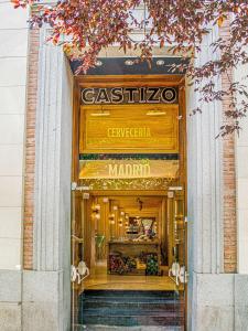 a store entrance to a store with stairs in front at NH Collection Madrid Palacio de Tepa in Madrid