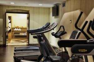 a gym with a row of exercise bikes in a room at NH Collection Madrid Palacio de Tepa in Madrid