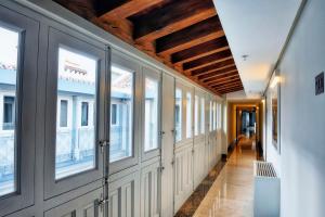 a hallway with windows on the side of a building at NH Collection Madrid Palacio de Tepa in Madrid