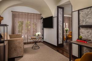 a living room with a couch and a table at NH Collection Madrid Palacio de Tepa in Madrid