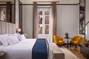 a hotel room with a bed and a window at NH Collection Madrid Palacio de Tepa in Madrid