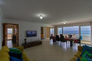 a living room with a view of the ocean at Sky Mariposa sospesa sul mare in Mindelo