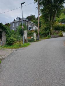 an empty street in front of a house at Little Bay View in Oban
