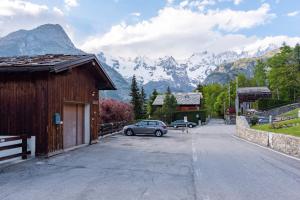 a car parked on a street with mountains in the background at Flat with Garden in Courmayeur - Happy Rentals in Courmayeur