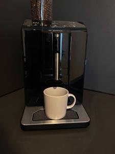 a coffee maker with a coffee cup on a table at Oh my Deer nagelneues Appartement für Zwei in Tauberbischofsheim +9 photos