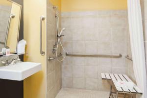 a bathroom with a sink and a shower at Microtel Inn & Suites in Dickson City +9 photos