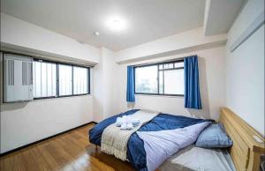 a bedroom with a bed with two candles on it at Have a nice day OSAKATENNOJI703 in Osaka