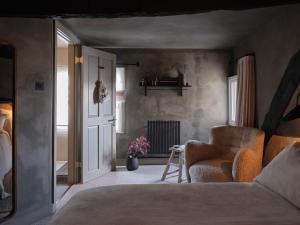 a bedroom with a bed and a chair and a window at Highway in Burford