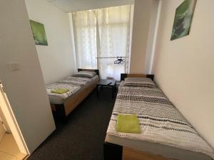 Postel nebo postele na pokoji v ubytování Apartmany Fit Gym