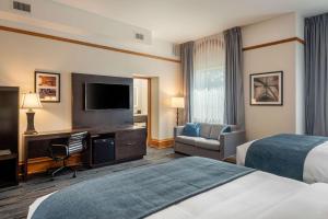 a hotel room with two beds and a flat screen tv at The Courthouse Hotel, an Ascend Collection Hotel in Thunder Bay +46 photos