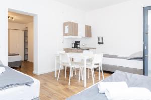 a room with a table and chairs and two beds at Z.Bilić V&V in Jesteburg