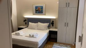 a bedroom with a bed with two towels on it at Vila Simfonija with Free parking in Vrnjačka Banja