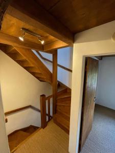 an attic room with wooden stairs in a house at Gite, Close To Hautecombe Abbey, Lac du Bourget in Grumeau