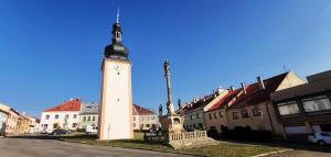 a clock tower in the middle of a town at Studio Na náměstí in Potštát
