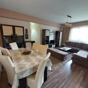 a living room with a table and a couch at Apartament Very BIG in Bistriţa