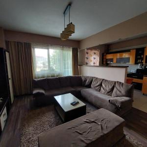 a living room with a couch and a table at Apartament Very BIG in Bistriţa