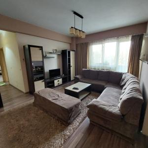 a living room with a couch and a table at Apartament Very BIG in Bistriţa