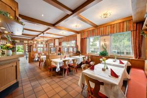 a restaurant with tables and chairs in a room at Jägerheim in Nuremberg