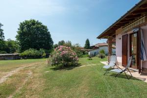 a couple of chairs sitting outside of a house at La Casa In Campagna 800m from lake - Happy Rentals in Leggiuno