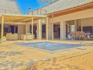 a swimming pool in the middle of a house at Rhino Lodge at Zebula in Mabula