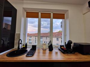 a kitchen counter with a sink and a window at Modern Studio 2 in Onești