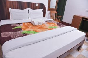 a hotel room with two beds with towels on it at Raahath Inn Munnar in Munnar