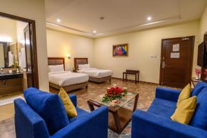 Postel nebo postele na pokoji v ubytování Hotel One Sahiwal