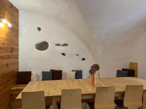 a dining room with a wooden table and chairs at The Stable House Bourg d’Oisans -bike/hike/ski in Le Bourg-dʼOisans +19 photos
