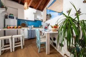 a kitchen with blue cabinets and a table and chairs at Casa Cueva in La Oliva +22 photos