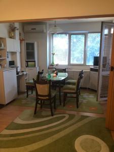 a kitchen and dining room with a table and chairs at Tanjas City Apartment in Varna City