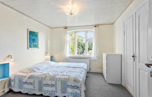 a bedroom with a bed and a window at 6 Bedroom Beautiful Home In Ærøskøbing in Ærøskøbing +31 photos