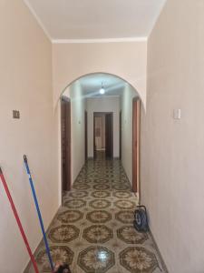 a hallway with a tile floor in a house at Casa Maluk in LMP