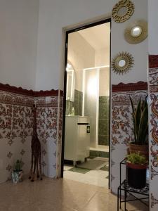 a bathroom with a shower with a giraffe standing in the doorway at Paraíso da Aldeia in São Bartolomeu de Messines