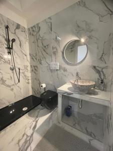 a bathroom with a sink and a toilet and a mirror at Villa Levante in Barletta