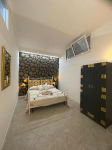 a bedroom with a bed and a tv on the wall at Villa Levante in Barletta