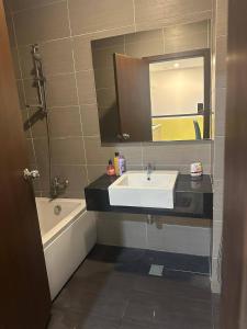 a bathroom with a sink and a tub and a mirror at JB City D'Esplanade Shopping mall apartment in Johor Bahru +48 photos