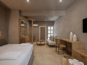 a bedroom with a bed and a living room at Hestia Boutique Rooms in Nea Kydonia