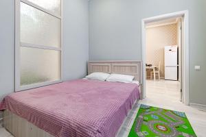 a bedroom with a bed with a purple blanket at Трех комнатные апартаменты в новом доме рядом с Батырмол in Pavlodar
