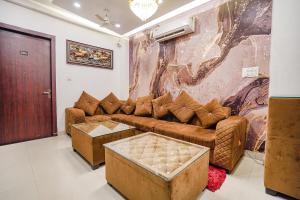 a living room with a couch and a table at FabHotel TS Inn in Faithfulganj