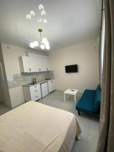 a bedroom with a bed and a blue couch at New House Gonio in Batumi +187 photos
