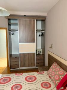 a bedroom with a bed and a large closet at Asinela Home с гараж in Burgas City