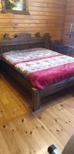 a bed in a room with a wooden floor at wooden villa in Mardakan +25 photos