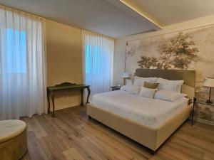 a bedroom with a large bed and a table at Villa Tosi - Luxury Apartments in Villa Veneta in Tregnago +43 photos