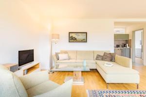 a living room with a couch and a tv at Apartment Premium Plus im Gustav Seitz Gästehaus in Trebnitz +14 photos
