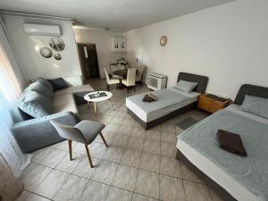a living room with two beds and a couch at Budget Friendly in Požega