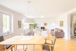 a dining room and living room with a table at Apartment Premium im Gustav Seitz Gästehaus in Trebnitz