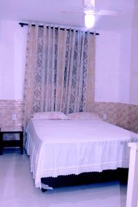 Ένα ή περισσότερα κρεβάτια σε δωμάτιο στο Casa da praia do Forte Bairro Passagem