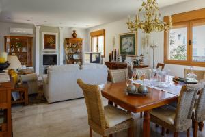 a dining room and living room with a table and chairs at BEACH VILLA with PRIVATE POOL in Palma de Mallorca