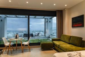 a living room with a couch and a table at Toumba apartments in Thessaloniki