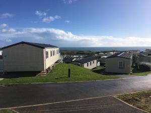 a house on the side of a road with houses at Devon Cliffs Exmouth Sandy Bay 3 bedrooms in Exmouth